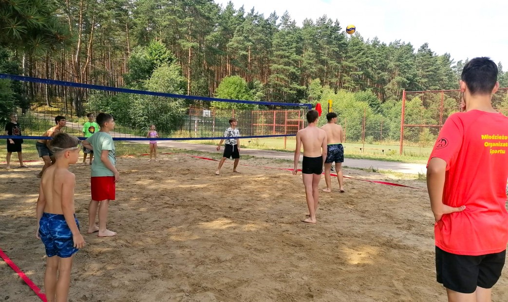 Chłopcy grający w siatkówke plażową